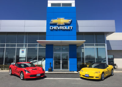 chev sign with red and yellow sports cars